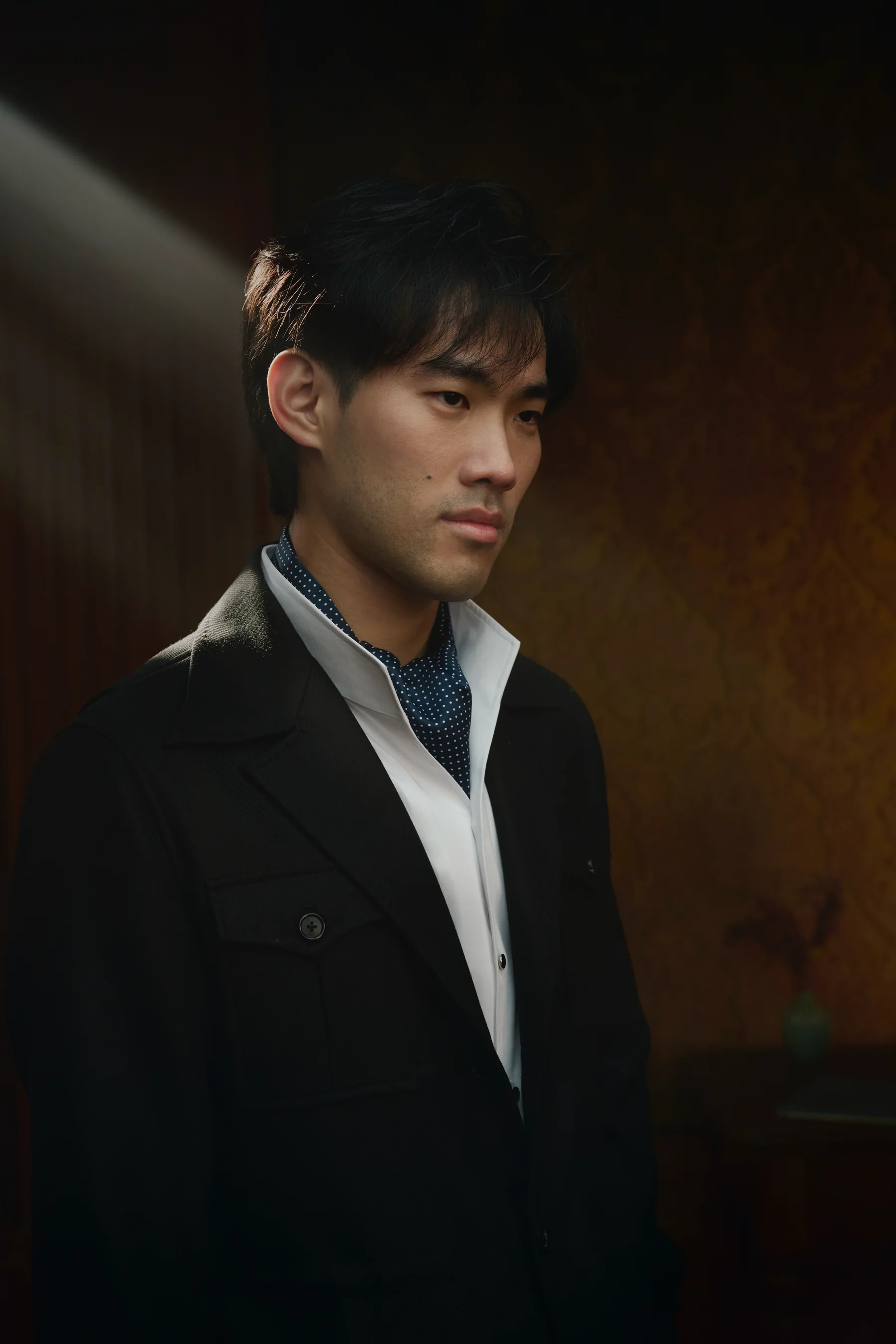 Formal portrait of Bruce Liu in a dark suit